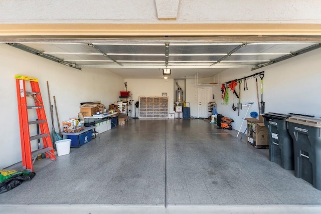 garage featuring a garage door opener and water heater