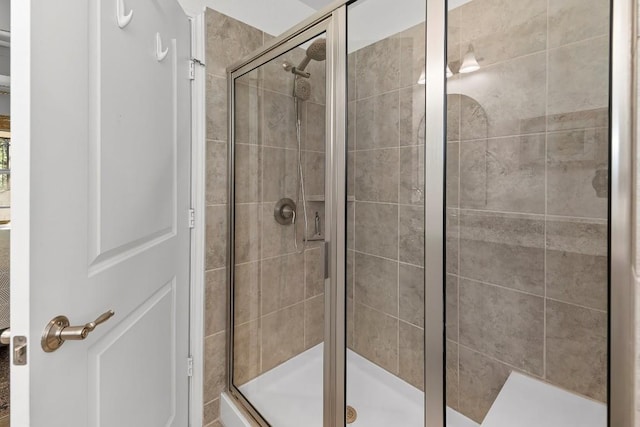 bathroom with a shower with door