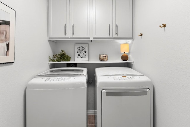 laundry room with cabinets and separate washer and dryer