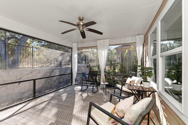 sunroom featuring ceiling fan