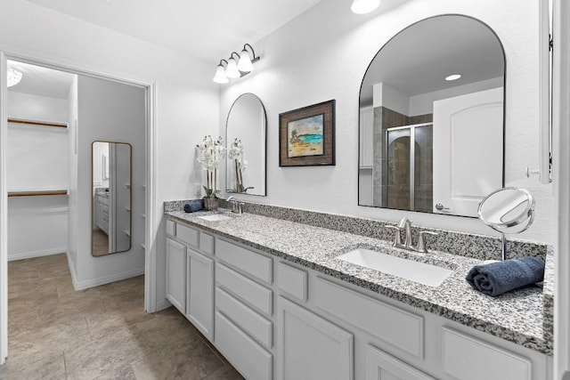 bathroom featuring an enclosed shower and vanity