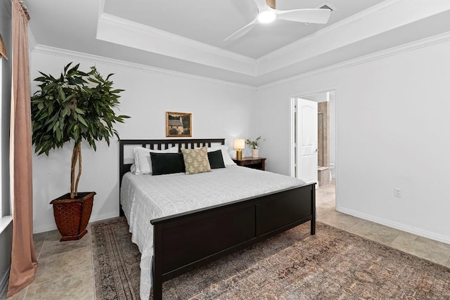 bedroom featuring a raised ceiling, ornamental molding, connected bathroom, and ceiling fan