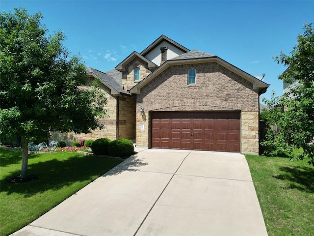view of front of house featuring stone siding, a front lawn, concrete driveway, and an attached garage