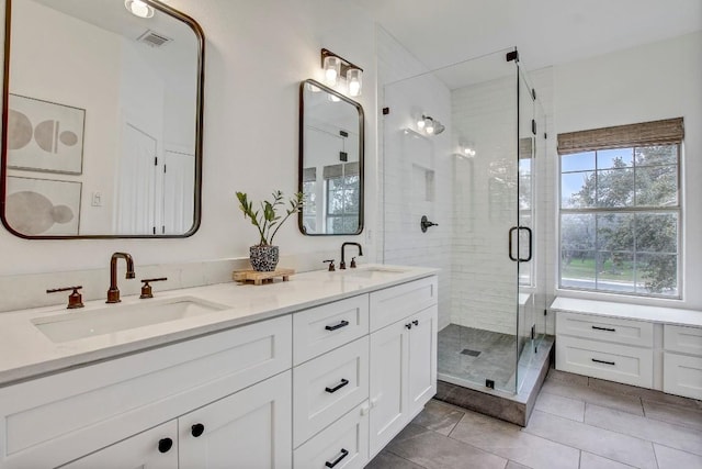 bathroom with vanity, tile patterned floors, and walk in shower