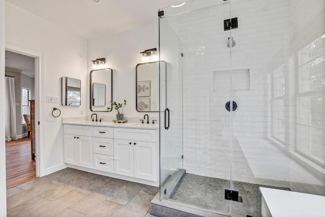 bathroom featuring vanity and a shower with door