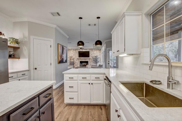 kitchen featuring white cabinetry, appliances with stainless steel finishes, sink, and ornamental molding