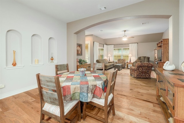 dining space with ceiling fan and light hardwood / wood-style floors