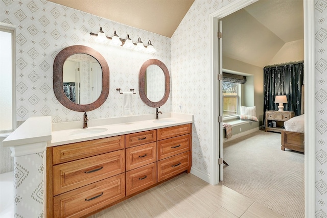 bathroom with lofted ceiling and vanity