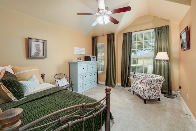 bedroom featuring ceiling fan, vaulted ceiling, and light carpet