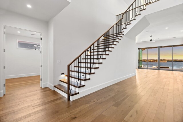 1409 Apache Tears, Horseshoe Bay, TX 78657 - staircase featuring ceiling fan, hardwood / wood-style flooring, a towering ceiling, and recessed lighting