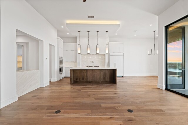 1409 Apache Tears, Horseshoe Bay, TX 78657 - kitchen with paneled built in refrigerator, white cabinets, light wood-style flooring, light countertops, and recessed lighting