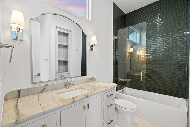 full bathroom with vanity, toilet, combined bath / shower with glass door, and a wealth of natural light