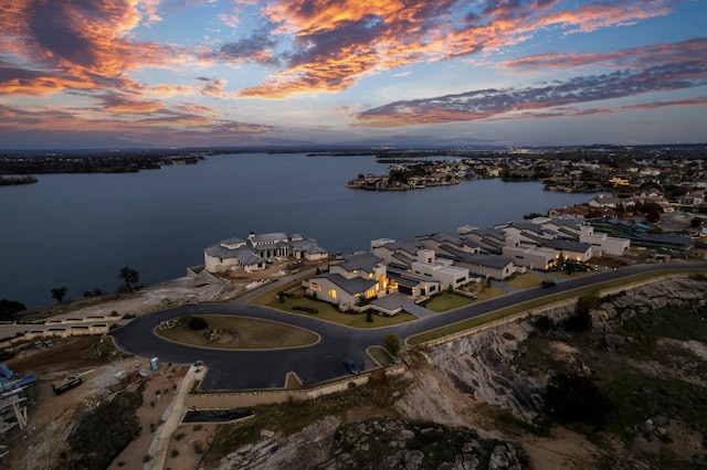 aerial view at dusk with a water view