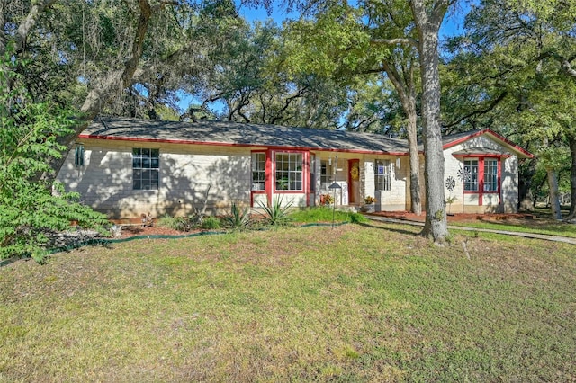 ranch-style home featuring a front yard