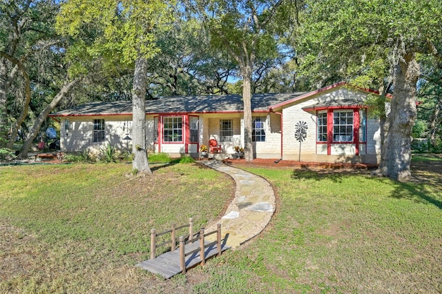 ranch-style home featuring a porch and a front yard