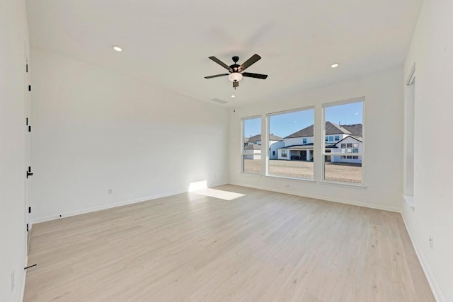 empty room with ceiling fan and light wood-type flooring