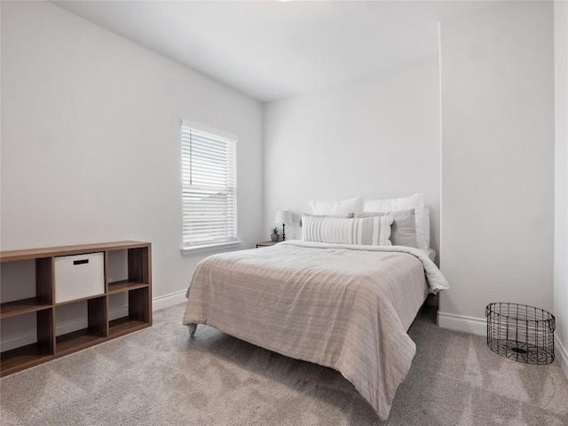 bedroom with carpet flooring and baseboards