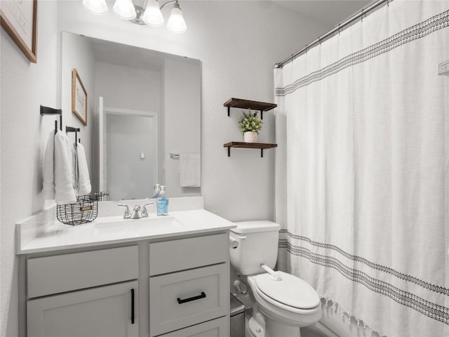 full bathroom featuring toilet and vanity