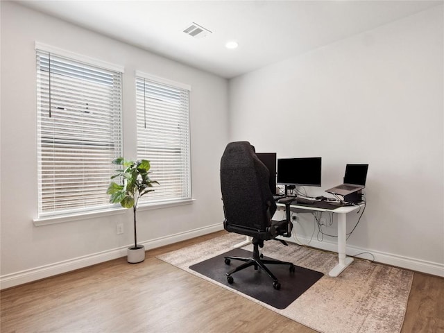 home office featuring recessed lighting, wood finished floors, visible vents, and baseboards