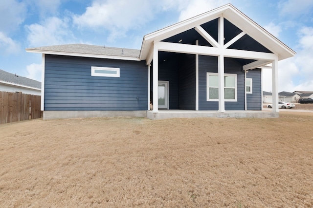 rear view of house with a yard