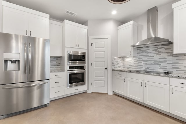 kitchen featuring white cabinetry, appliances with stainless steel finishes, and wall chimney exhaust hood