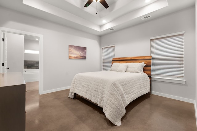 bedroom with ceiling fan and a raised ceiling