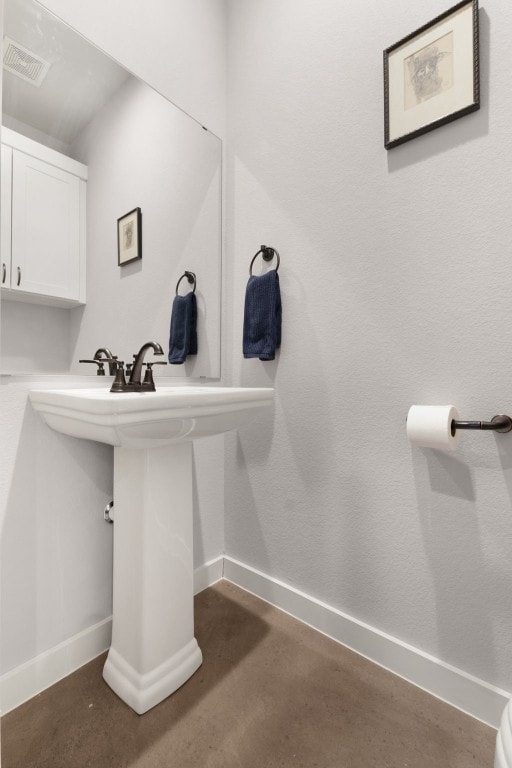 bathroom with concrete flooring