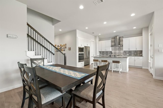 dining space with light hardwood / wood-style flooring