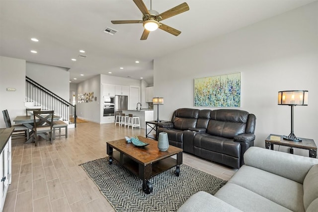 living room with sink and ceiling fan