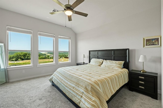 bedroom with ceiling fan, light colored carpet, and vaulted ceiling