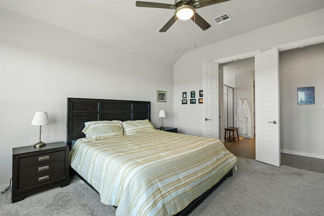 bedroom featuring ceiling fan, lofted ceiling, and light carpet