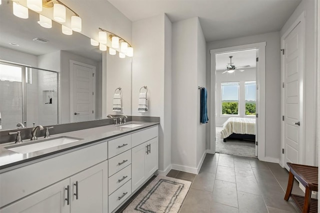 bathroom featuring vanity, a shower with door, and tile patterned flooring