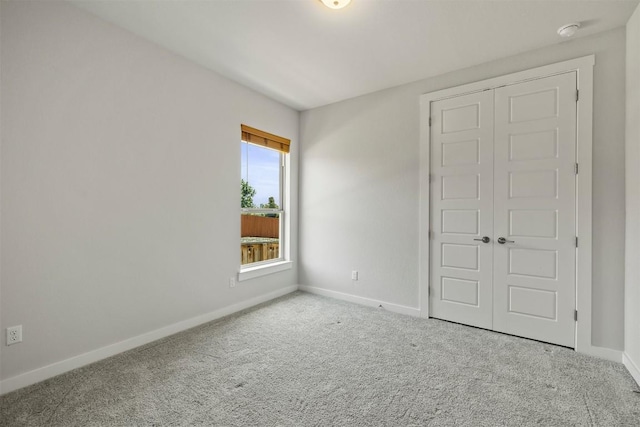 unfurnished bedroom with a closet and carpet flooring