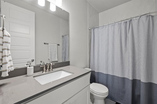 bathroom featuring vanity, toilet, and curtained shower