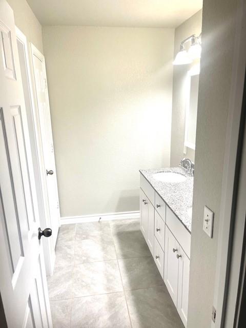 bathroom with vanity and tile patterned flooring