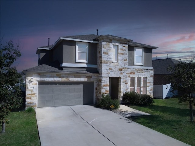 view of front of home featuring a garage and a yard