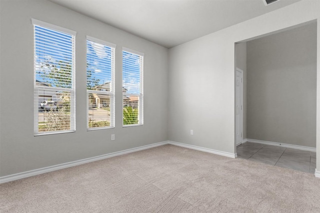 unfurnished room featuring light colored carpet