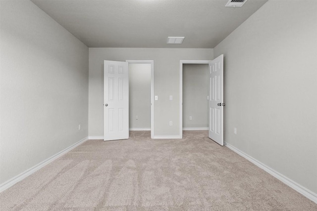 unfurnished bedroom featuring light colored carpet