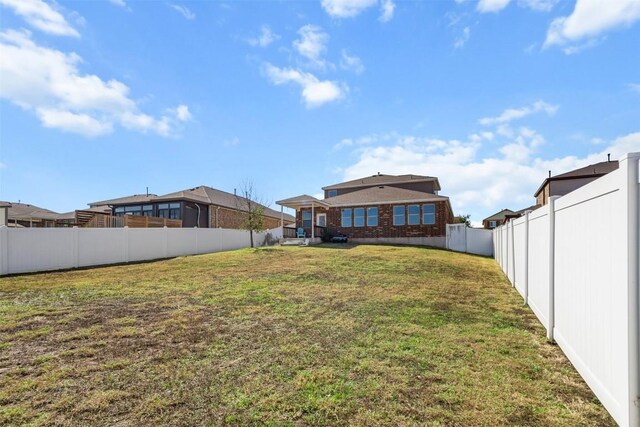 back of property featuring a lawn