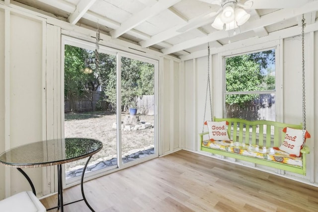 unfurnished sunroom with beamed ceiling and plenty of natural light