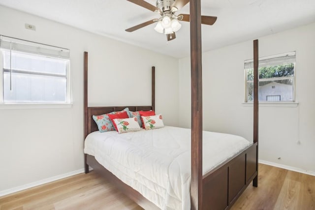 bedroom with light hardwood / wood-style flooring and ceiling fan