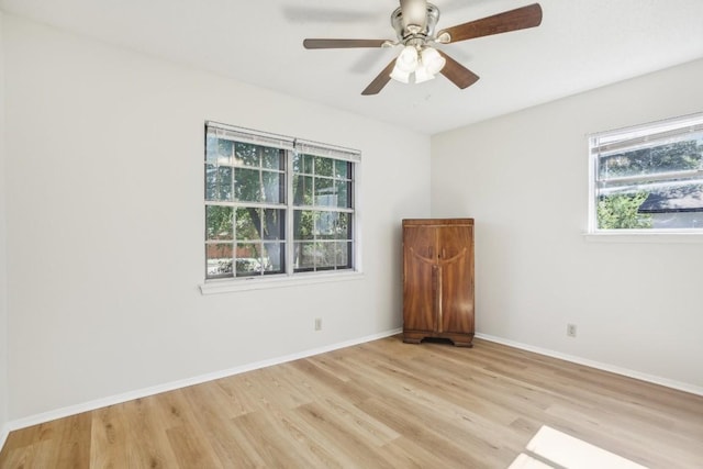 spare room featuring ceiling fan and light hardwood / wood-style floors