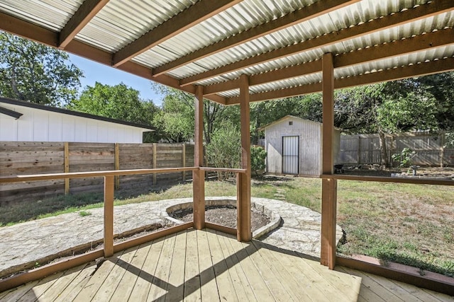 wooden deck featuring a storage shed