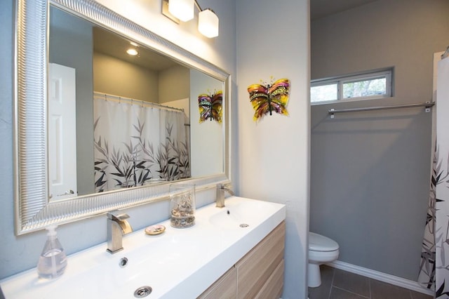 bathroom featuring vanity, tile patterned floors, and toilet