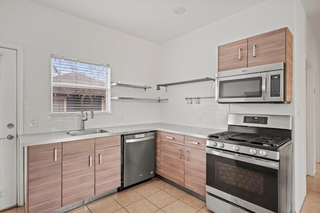 kitchen with light tile patterned floors, stainless steel appliances, sink, and backsplash