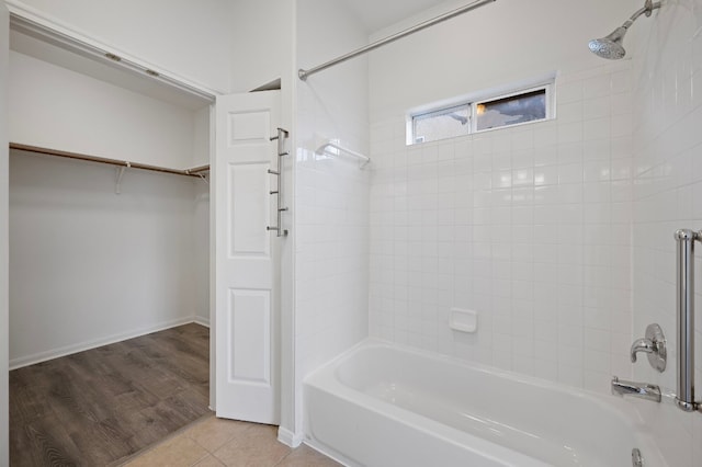 bathroom with tile patterned flooring and tiled shower / bath combo