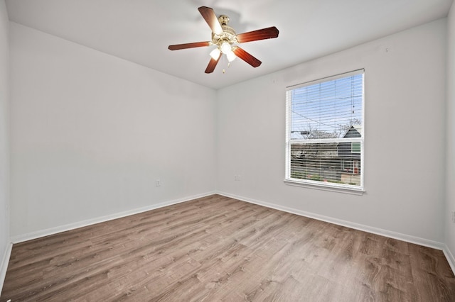 spare room with light hardwood / wood-style flooring and ceiling fan