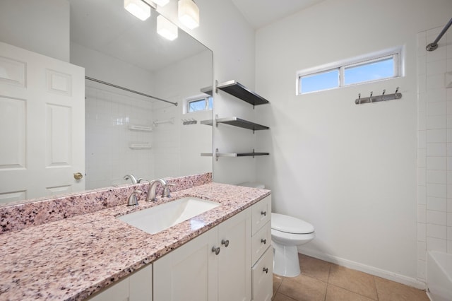 full bathroom with tile patterned flooring, vanity, tiled shower / bath, and toilet