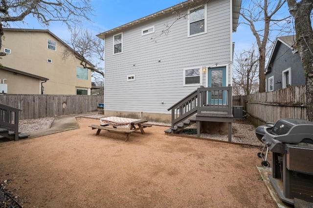 rear view of property featuring a patio and central AC