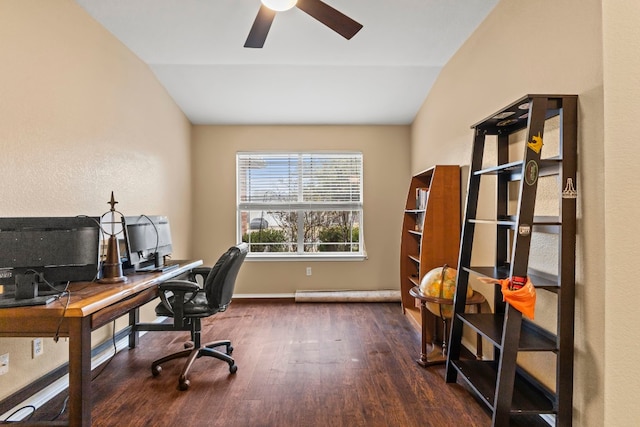 office space featuring ceiling fan, dark hardwood / wood-style floors, and vaulted ceiling